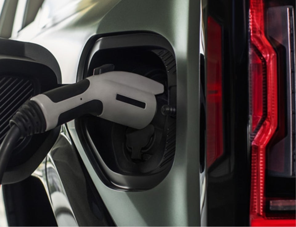 Close up of charging port with charger plugged in on a GMC Hummer EV SUV - Ed Morse GMC in KEWANEE IL