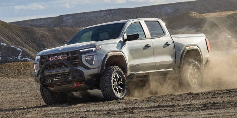 2026 GMC Sierra 1500 Denali driving on rugged terrain demonstrating confident capability