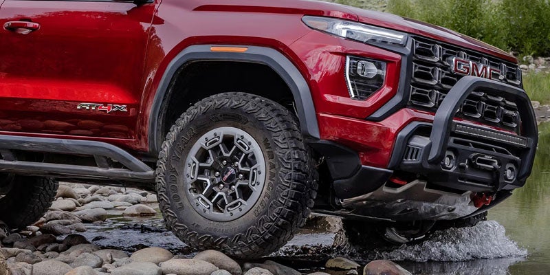 Front quarter view of the 2026 GMC Canyon showcasing bold styling and available trims