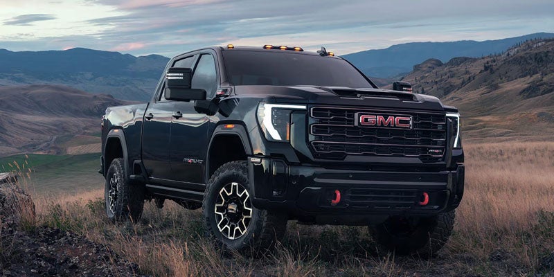 2026 GMC Sierra 2500 HD AT4X parked on a rugged mountain landscape in Kewanee, IL