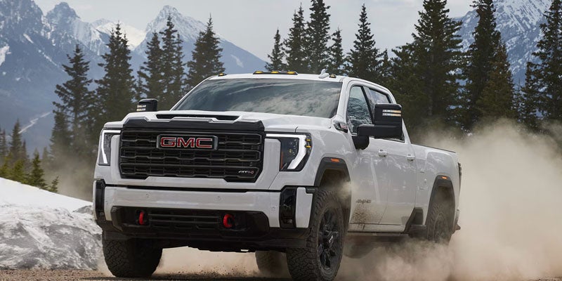 2026 GMC Sierra 2500 HD AT4X driving off-road to demonstrate heavy-duty capability