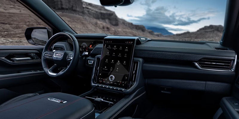 Premium interior of the 2026 GMC Yukon XL featuring three-row seating and a spacious cabin