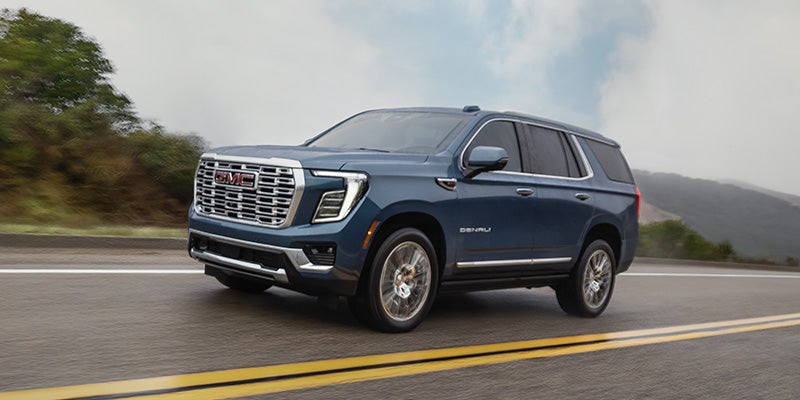 2026 GMC Yukon XL driving on the highway showcasing confident performance in Kewanee, IL
